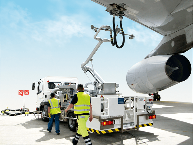 Aviation refueling operation with ground crew using a hydrant dispenser system to refuel an aircraft at an airport