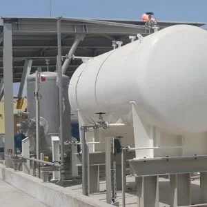 Industrial facility featuring large white storage tanks